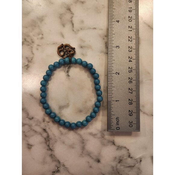 Turquoise Blue Beaded Bracelet With Bronze Om Symbol Charm - Picture 2 of 3